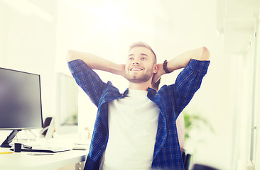 Image showing happy creative man with computer at office