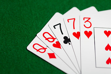 Image showing poker hand of playing cards on green casino cloth