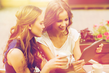 Image showing young women with tablet pc and coffee at cafe