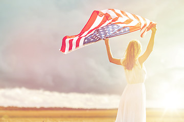 Image showing happy woman with american flag on cereal field