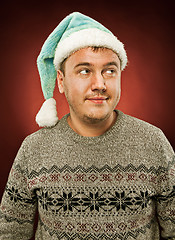 Image showing Surprised christmas man wearing a santa hat