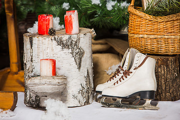 Image showing Vintage ice skates for figure skating with fir tree branch hanging on rustic background.