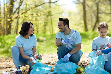 Image showing volunteers with garbage bags cleaning park area