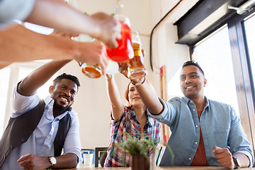 Image showing friends clinking glasses with drinks at restaurant