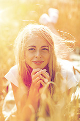 Image showing happy woman or teen girl lying in cereal field