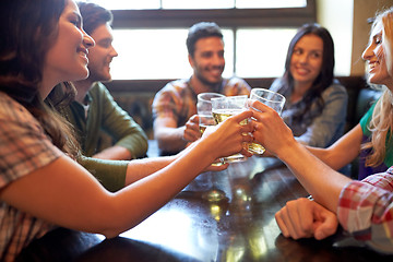 Image showing happy friends drinking beer at bar or pub