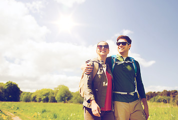 Image showing happy couple with backpacks hiking outdoors