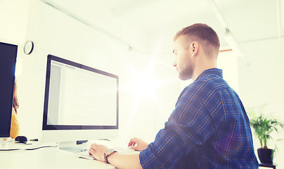 Image showing creative man or programmer with computer at office