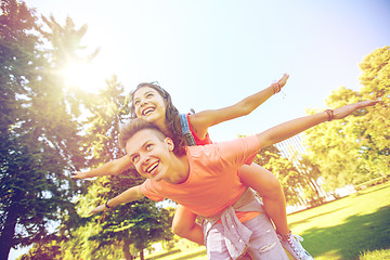 Image showing happy teenage couple having fun at summer park