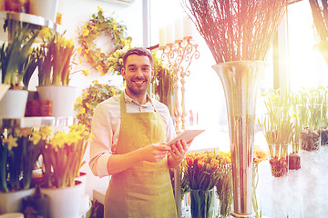 Image showing man with tablet pc computer at flower shop