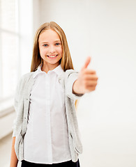 Image showing happy smiling student girl showing thumbs up