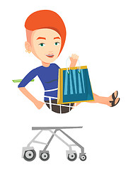 Image showing Happy woman riding by shopping trolley.