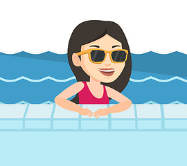 Image showing Smiling young woman in swimming pool.