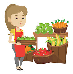 Image showing Supermarket worker with box full of apples.