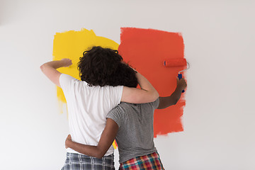 Image showing multiethnic couple painting interior wall