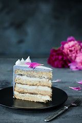 Image showing Slice of Birthday Cake with a flowers over a blue background.