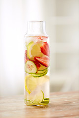 Image showing close up of fruit water in glass bottle