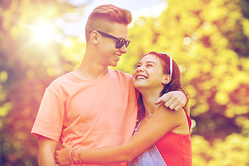 Image showing happy teenage couple looking at each other in park