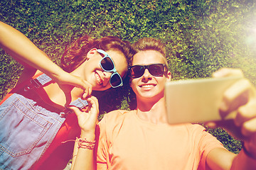 Image showing happy couple taking selfie on smartphone at summer