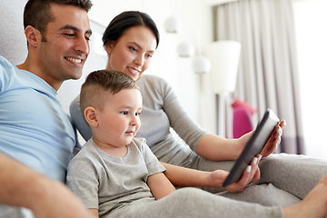 Image showing happy family with tablet pc in bed at home