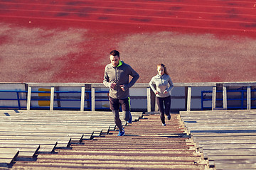 Image showing couple running upstairs on stadium