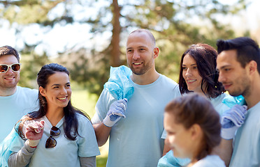 Image showing volunteers with garbage bags walking outdoors