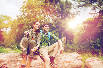 Image showing smiling couple with backpacks in nature