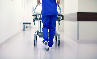 Image showing nurse carrying hospital gurney to emergency room