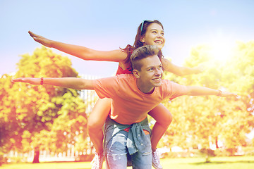 Image showing happy teenage couple having fun at summer park