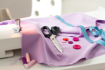 Image showing sewing machine, scissors, buttons and fabric