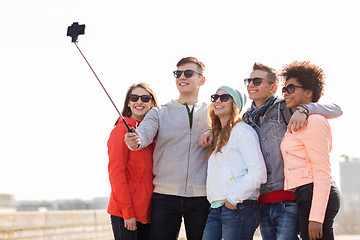 Image showing happy friends taking selfie by smartphone outdoors