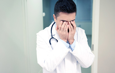 Image showing sad or crying male doctor at hospital ward