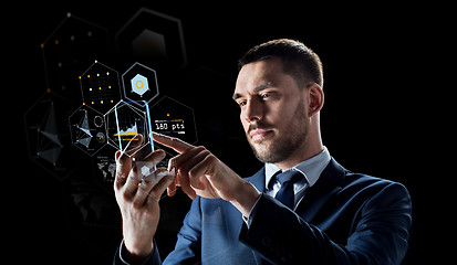 Image showing businessman with smartphone and virtual holograms