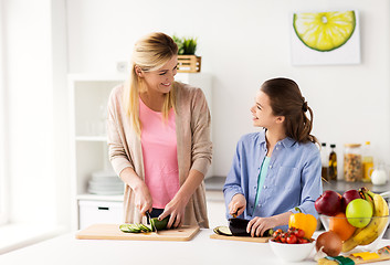 Image showing happy family cooking dinner at home kitchen