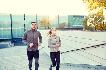 Image showing happy couple running upstairs on city stairs