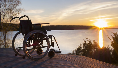 Image showing Empty wheelchair standing in a park