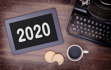 Image showing Tablet touch computer gadget on wooden table - 2020