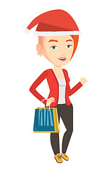 Image showing Woman in santa hat shopping for christmas gifts.