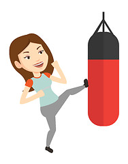 Image showing Woman exercising with punching bag.