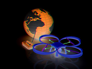 Image showing Quadrocopter Drone with Earth Globe and remote controller on a w