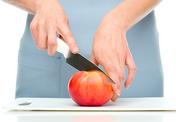 Image showing Cook is chopping apple
