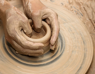 Image showing Hands in clay at process of making ceramic on pottery wheel