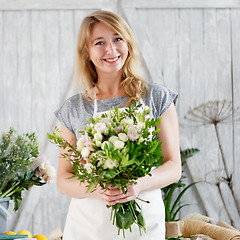 Image showing Florists girl working with flowers