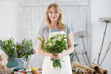 Image showing Florist blonde at flower shop