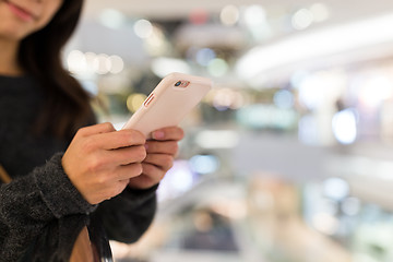 Image showing Woman use of mobile phone in shopping mall