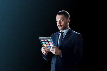 Image showing businessman working with transparent tablet pc