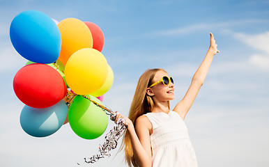 Image showing happy girl in sunglasses with air balloons