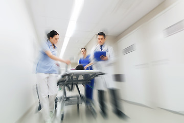 Image showing medics and patient on hospital gurney at emergency