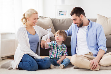 Image showing happy family playing with toy wind turbine