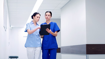 Image showing two medics or nurses at hospital with clipboard